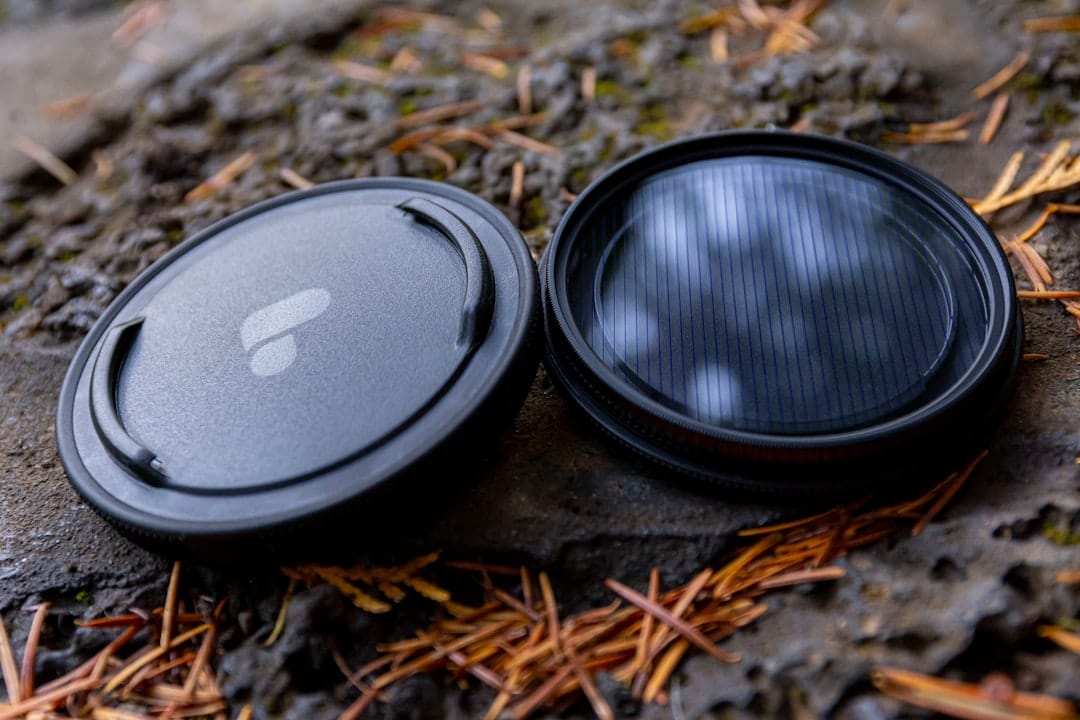 Photo by Leo_Visions a close up of a camera lens on the ground